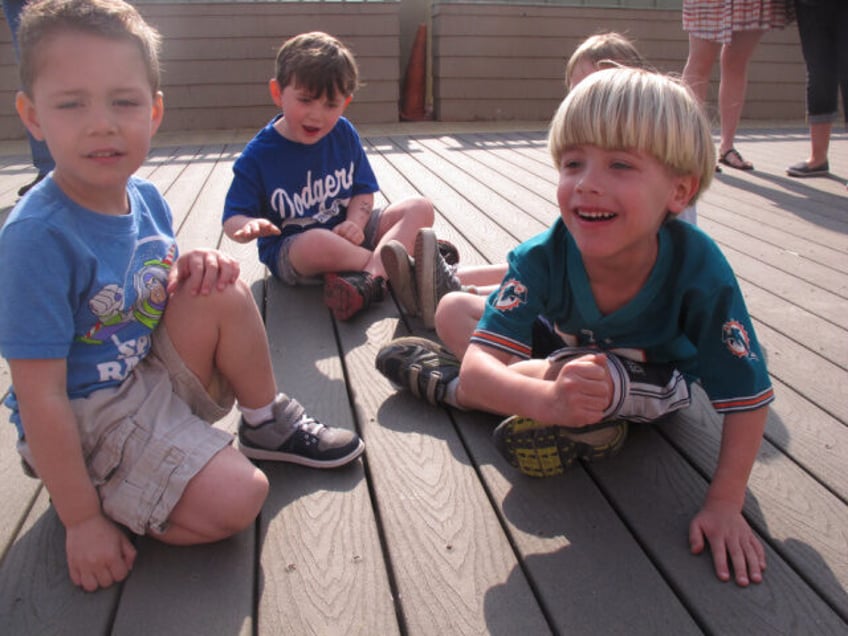 Evan Salas, left; Donovan Flynn, center, and Ben Costello, right, play on the boardwalk in