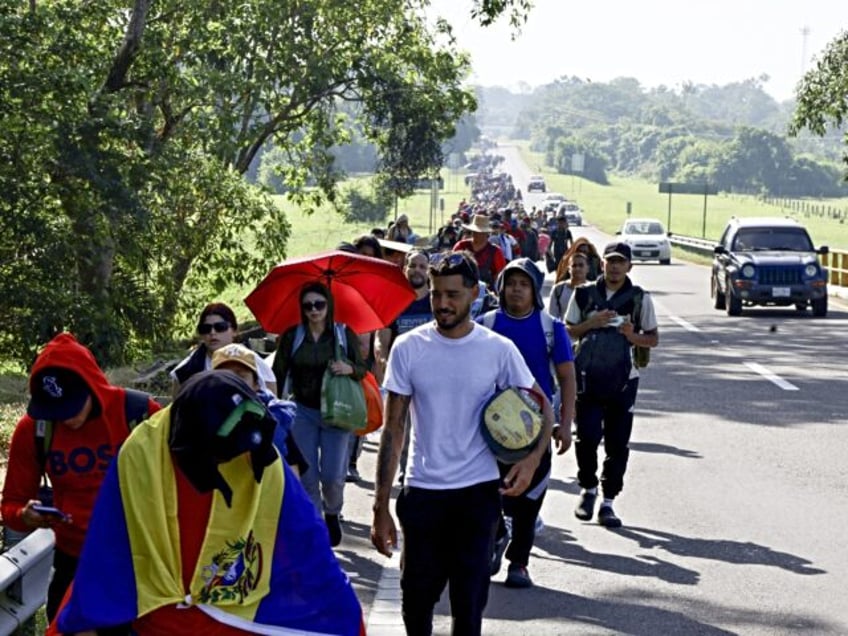 VILLA COMALTITLAN, MEXICO - DECEMBER 3: Migrants advance in a caravan en route to the Unit