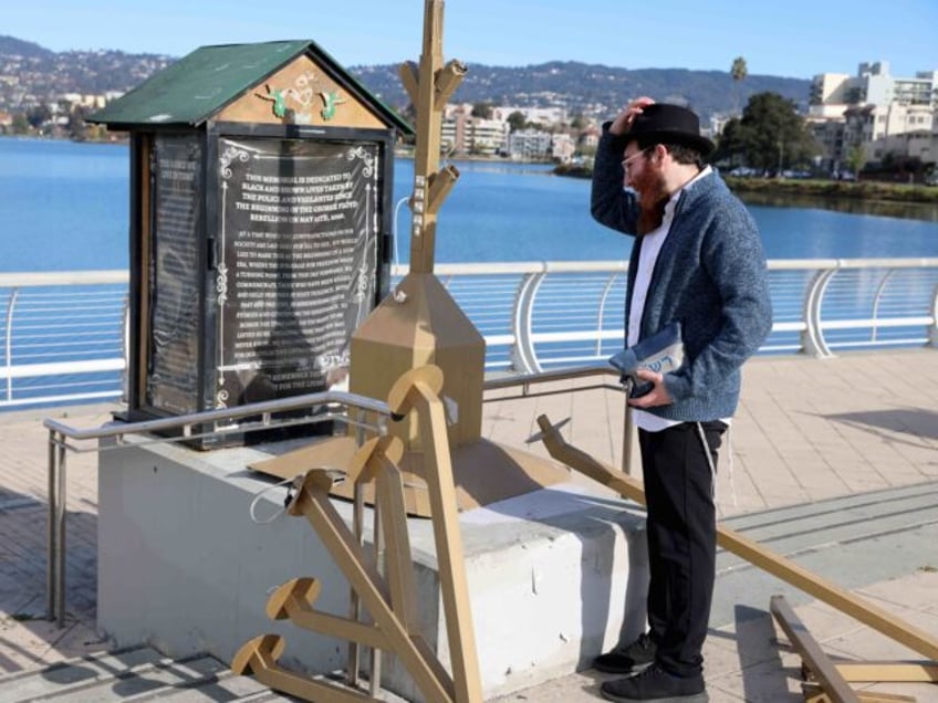 OAKLAND, CALIFORNIA - DECEMBER 13: Rabbi in training Moshe Turk, of the Chabad Jewish Center of Oakland, looks at a damaged menorah at the Lake Merritt Amphitheater in Oakland, Calif., on Wednesday, Dec. 13, 2023. Vandals on Tuesday night destroyed the large menorah which was set out for the public. …