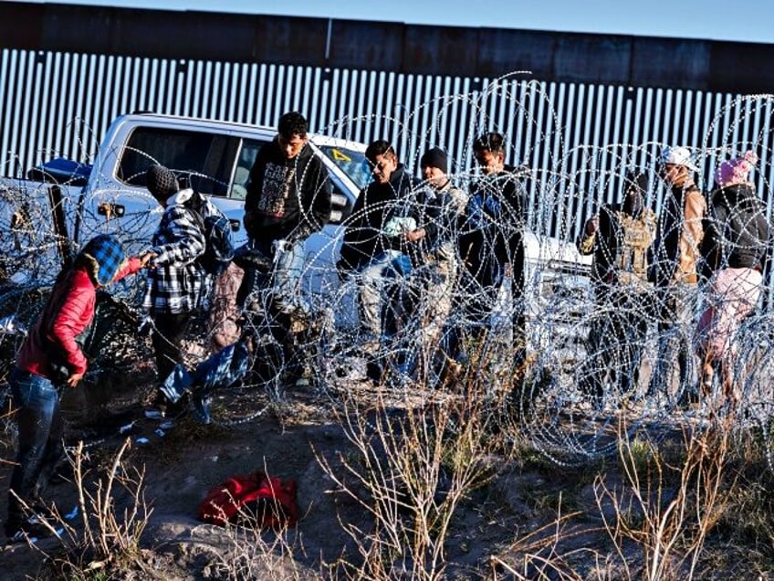 Migrants are sent back by the Texas National Guard to the Rio Grande after entering El Pas