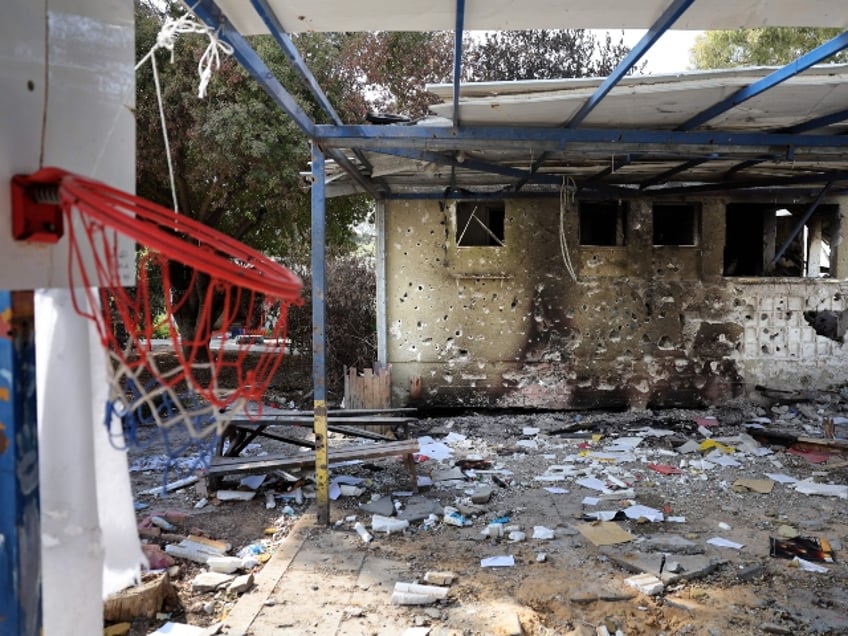 In this picture taken during a media tour organised by the Israeli military on October 22, 2023, paper and debris are strewn outside a burnt house riddled with bullets as it stands empty in the Israeli Kibbutz Beeri along the border with the Gaza Strip, in the aftermath of a Palestinian militant attack on October 7. (Photo by Thomas COEX / AFP) (Photo by THOMAS COEX/AFP via Getty Images)