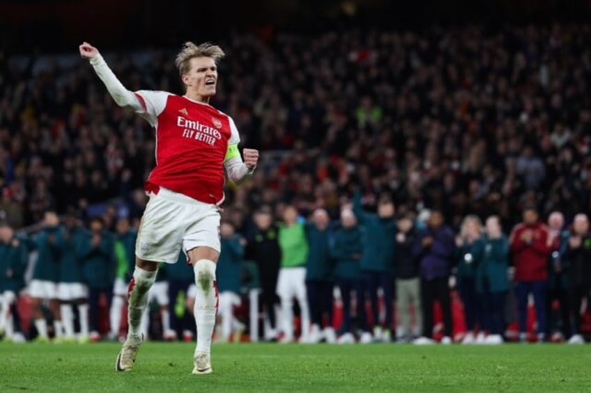 Arsenal captain Martin Odegaard celebrates after scoring during the Champions League penal