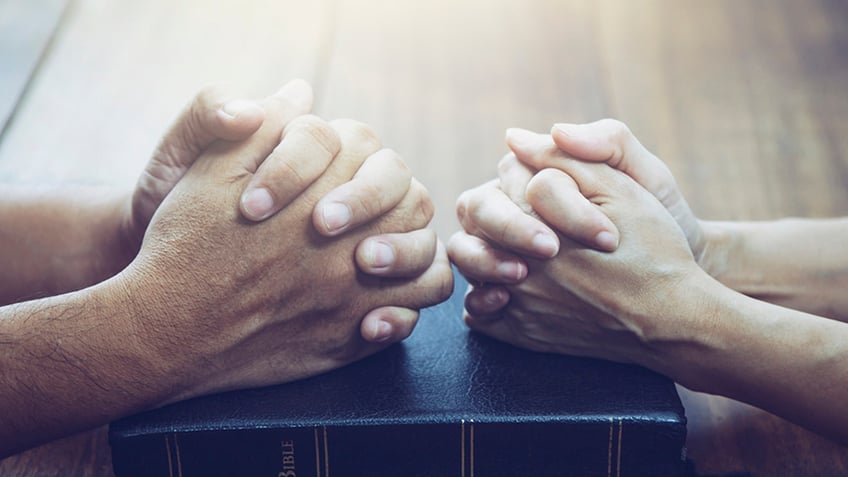 image of two pairs of hands praying