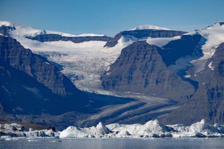 A photograph taken in Scoresby Fjord, Estarn Greenland shows a partly melted glacier