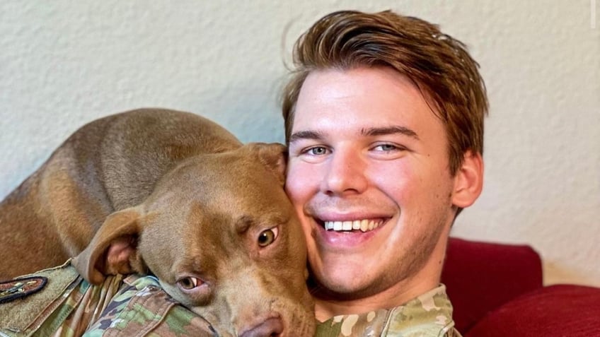 Joseph Lopez pictures in a military uniform with a dog