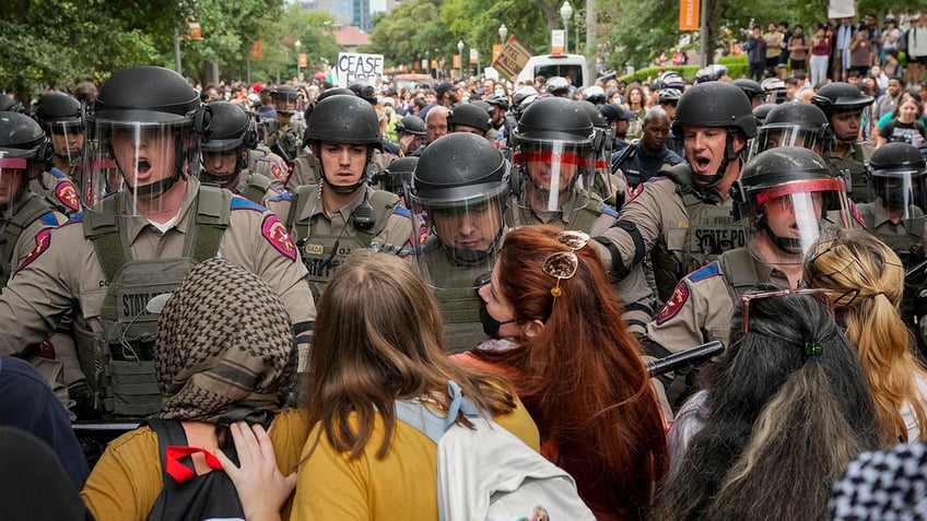 State troopers in riot gear try to beak up a pro-Palestinan protest