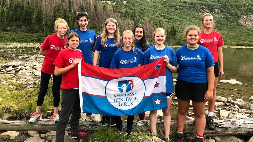 American Heritage Girls outside with banner