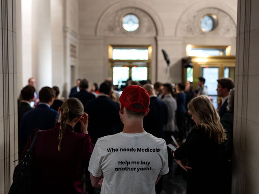 A demonstrator outside a House Ways and Means Committee markup of US President Donald Trum