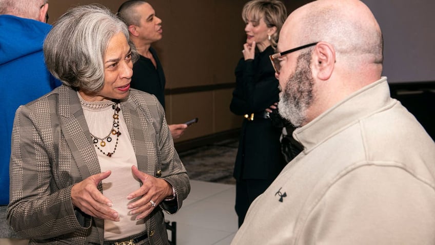 Terri Jamison, Democratic candidate for the Ohio Supreme Court, left, speaks with Waleed Abukhaled of Kent, Ohio, at a candidates forum sponsored by the Arab American Voter Project and the Council on American-Islamic Relations