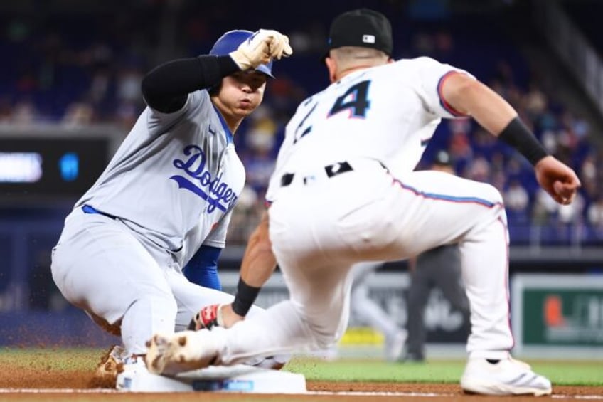 Dodgers star Shohei Ohtani beats the tag by Miami Marlins third baseman Connor Norby to po