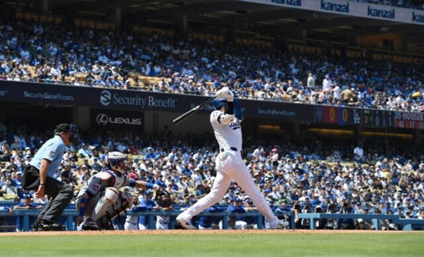 Shohei Ohtani of the Los Angeles Dodgers hits his 176th career home run to surpass Hideki