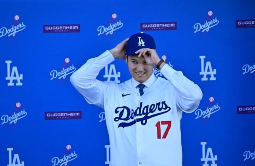 Japanese superstar Shohei Ohtani dons the cap and jersey of his new Major League Baseball club, the Los Angeles Dodgers