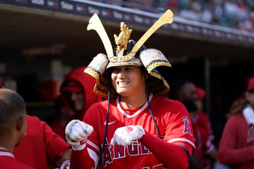 ohtani throws 1st mlb shutout hits 2 hrs as angels sweep tigers in dh team says hes staying