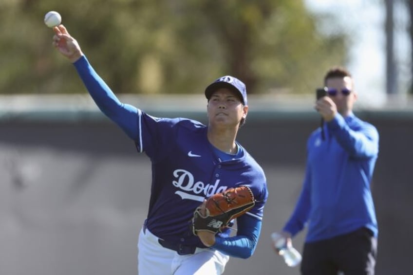 Japanese two-way star Shohei Ohtani warms up during a workout at Los Angeles Dodgers sprin