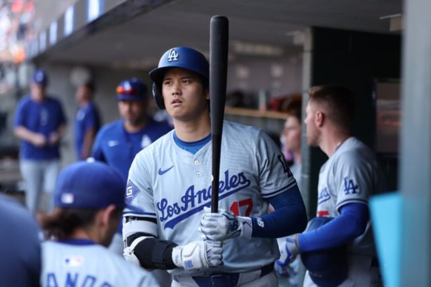 Los Angeles Dodgers star Shohei Ohtani looks on from the dugout prior to a Major League Ba