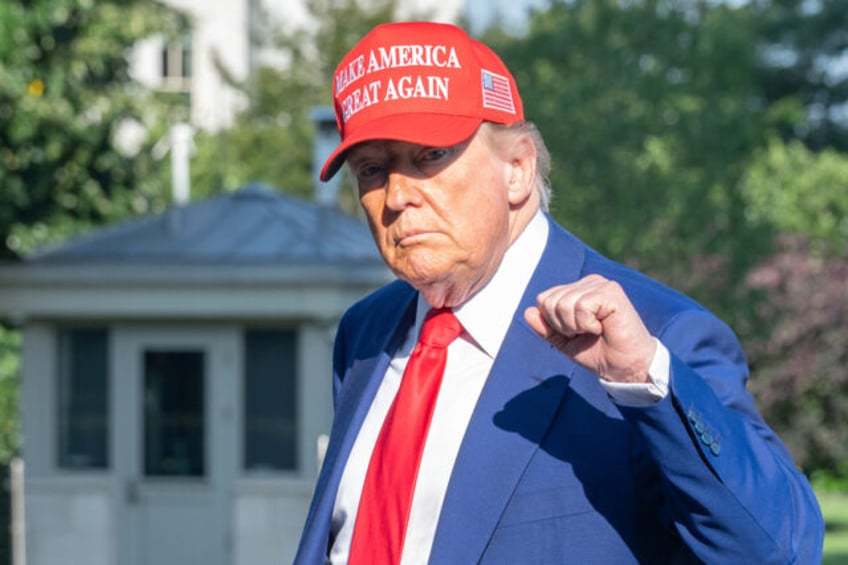 US President Donald Trump walks on the South Lawn of the White House after arriving on Mar