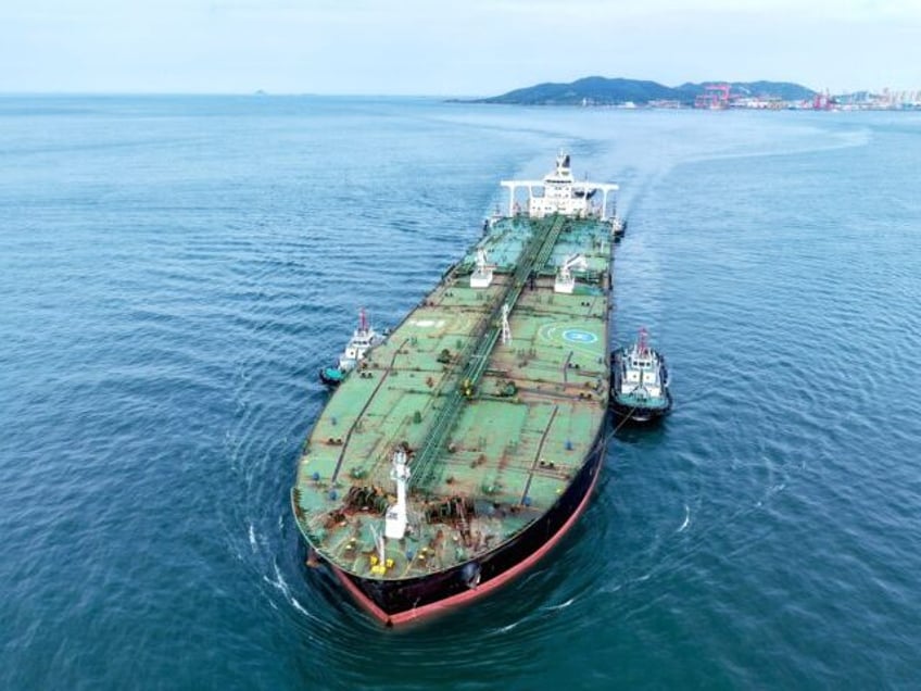An oil tanker carrying imported crude oil, assisted by a tugboat, heads for Qingdao Port i