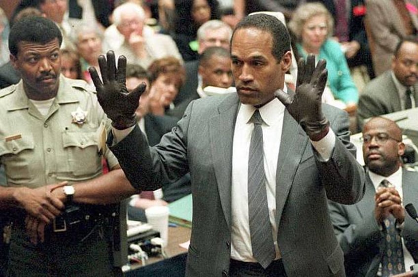 Simpson shows the jury a new pair of Aris extra-large gloves, similar to the gloves found at the Bundy and Rockingham crime scene 21 June 1995,...