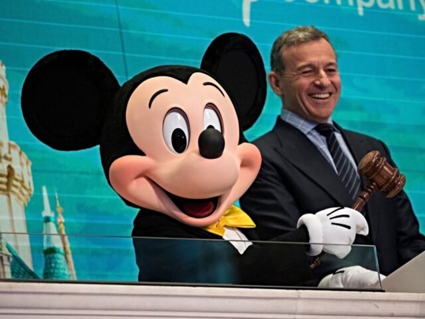 NEW YORK, NY - NOVEMBER 27: (L to R) Mickey Mouse and chief executive officer and chairman