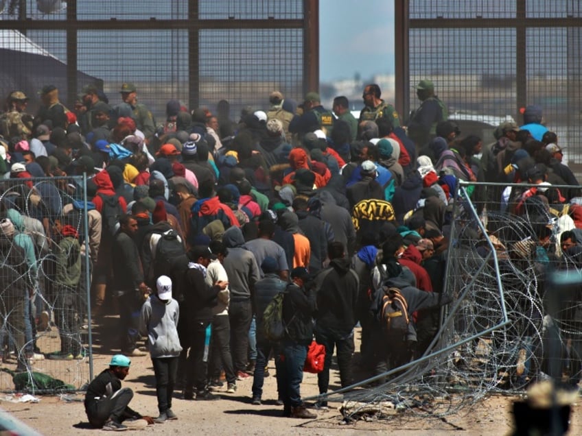 CIUDAD JUAREZ , MEXICO - MARCH 21: Hundreds of foreigners who camped at the border, broke the fence with their hands, sticks and different tools they had, placed blankets over the spikes and entered the United States, through the area known as Gate 36 in Ciudad Juarez, Mexico on March 21, 2024. American authorities kneeled migrants waiting to be processed. On the Mexican side, an operation is implemented by the Municipal Police and the National Migration Institute, who they remained waiting for what might happen. (Photo by Christian Torres/Anadolu via Getty Images)