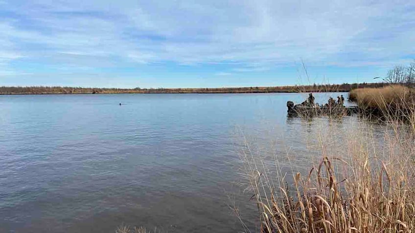 officials in boat on Sooner Lake