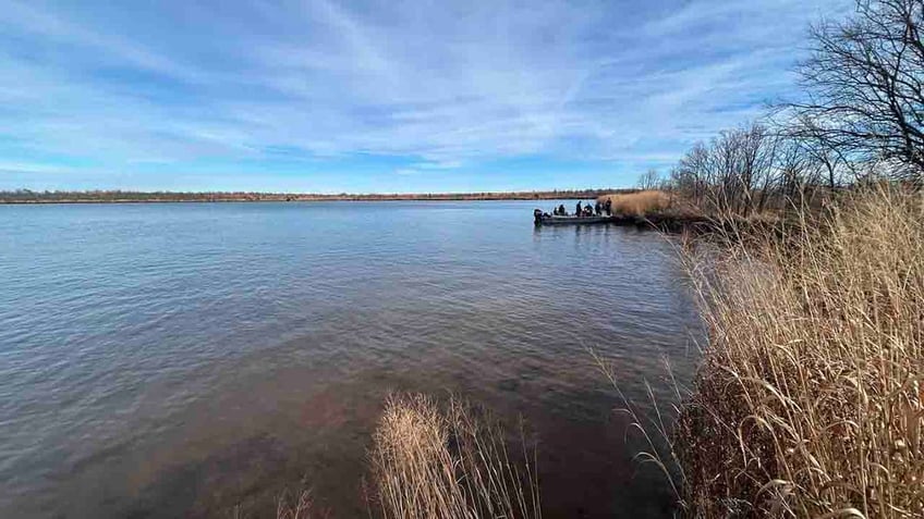 officials in boat on Sooner Lake