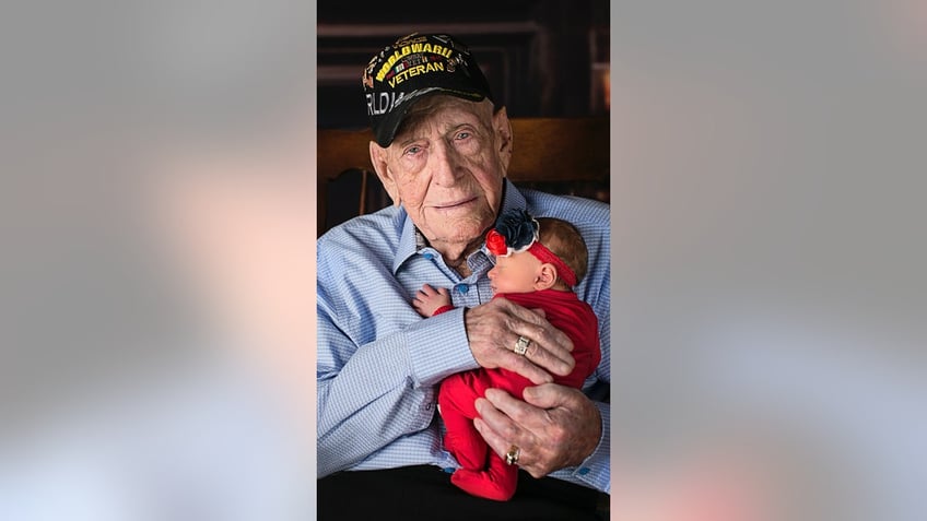 WWII vet holding great great grandaughter