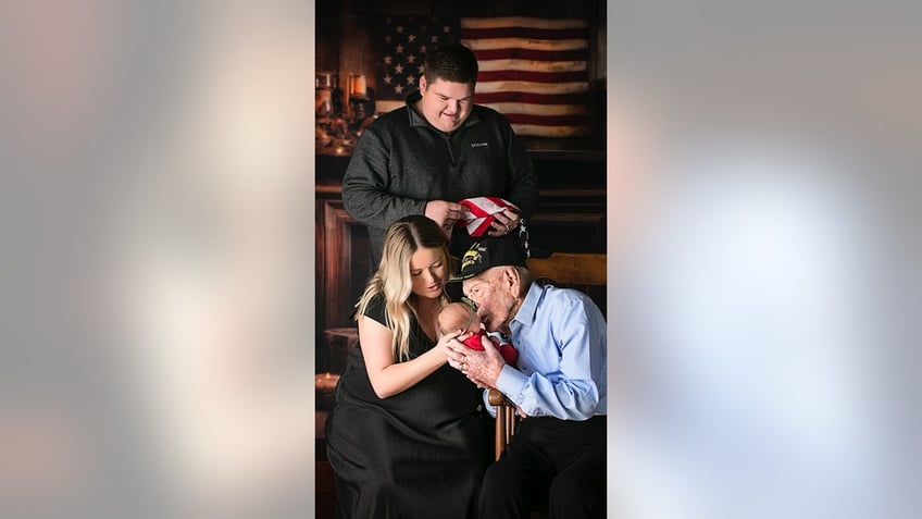 WWII vet holding great great grandaughter