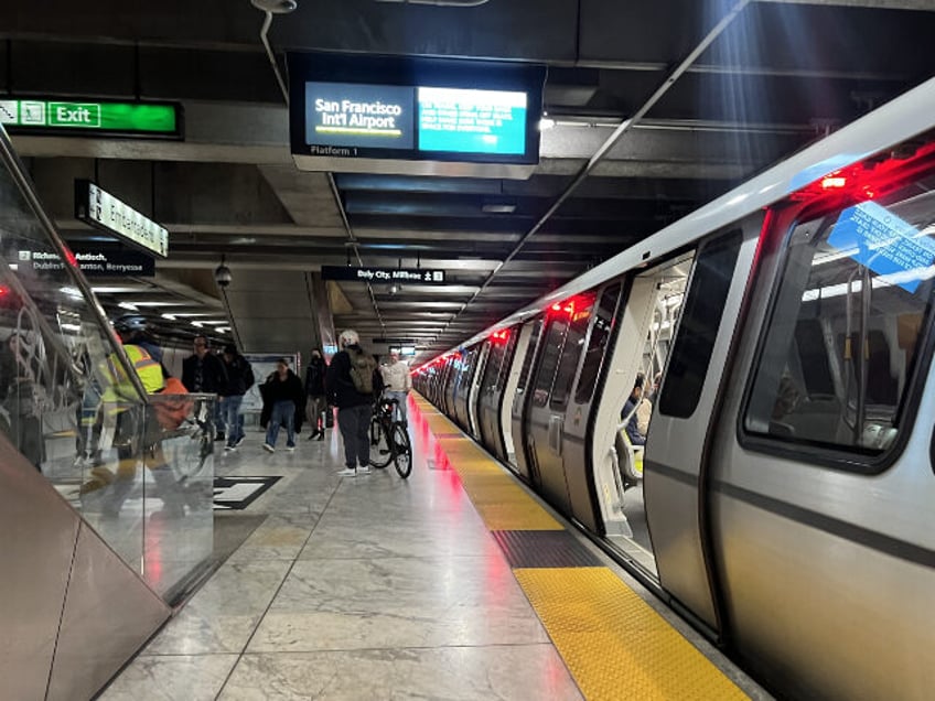 Bay Area Rapid Transit (BART) train stopped at Embarcadero Station, with commuters waiting