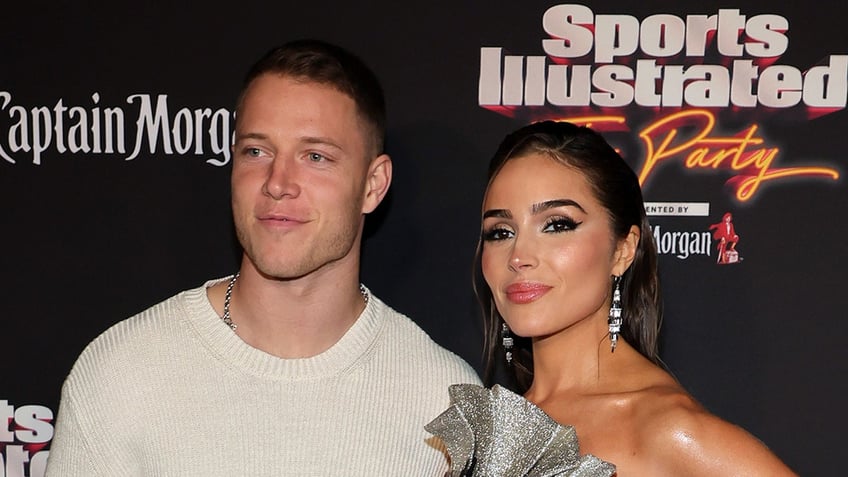 Christian McCaffrey and Olivia Culpo poses for picture