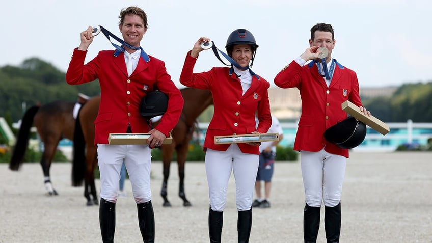 Karl Cook, Laura Kraut, and McLain Ward pose