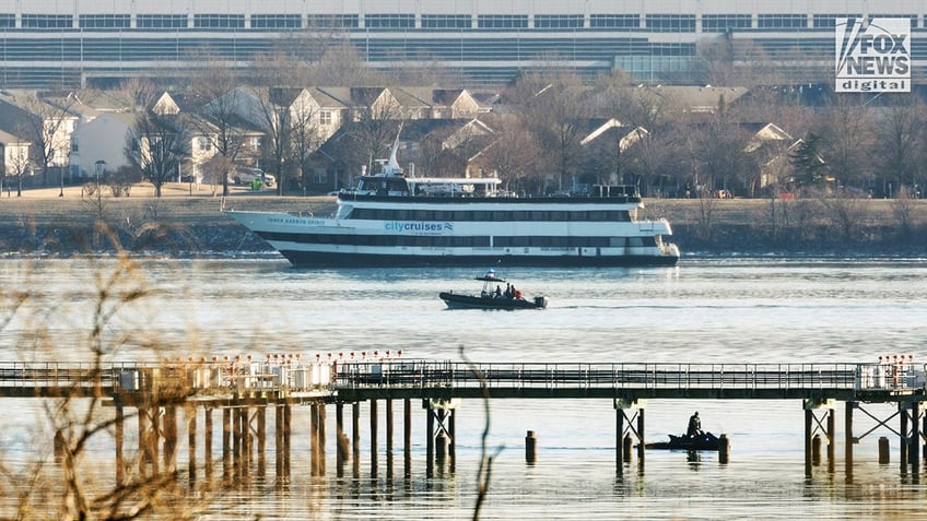 Emergency response units respond to the crash site of an American Airlines plane and Black Hawk helicopter on the Potomac River