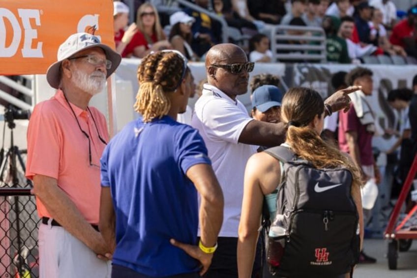 US Olympics great Carl Lewis (2nd R) interacts with members of the audience and athletes a
