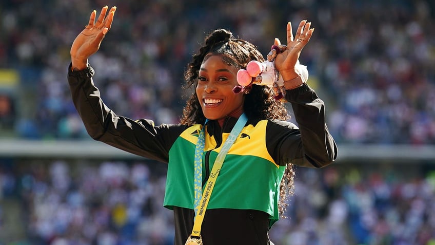 Elaine Thompson-Herah celebrates gold medal