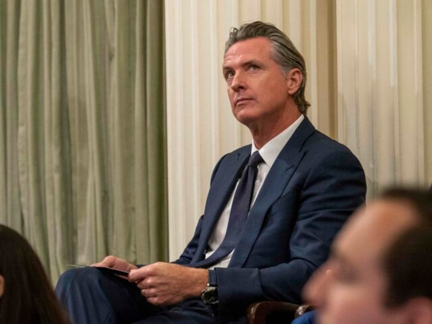 California Gov. Gavin Newsom looks up at the gallery at the swearing-in ceremony for Calif