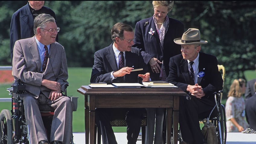 on this day in history july 26 1990 president george hw bush signs americans with disabilities act