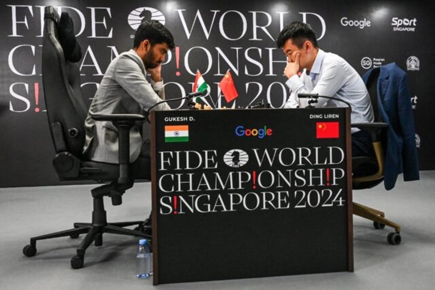 World chess champion Chinese Ding Liren, 32, is defending his crown against 18-year-old In