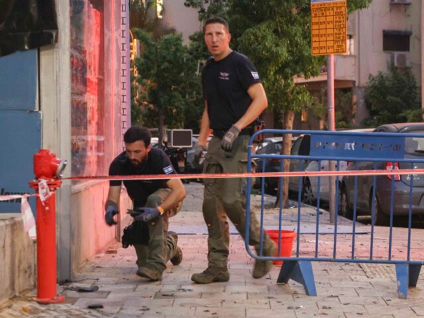 Members of the Israeli security forces are seen at a cordoned-off area where an explosion