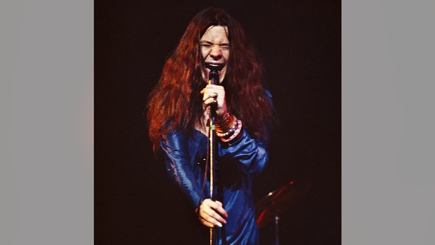 Janis Joplin singing into microphone