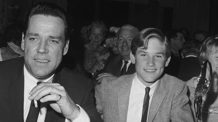 October 1966: American actor Kurt Russell (C) smiles at the Spotlighter Teen Awards dinner with his parents, Bing and Louise Russell. (Photo by Max B. Miller/Fotos International/Getty Images)