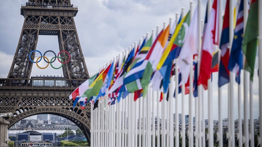 A view of the Eiffel Tower with the Olympics rings pictured with national flags of competing countries from the Place du Trocadero ahead of Paris 2024 Olympic Games on July 21, 2024 in Paris, France. (Photo by Kevin Voigt/GettyImages)