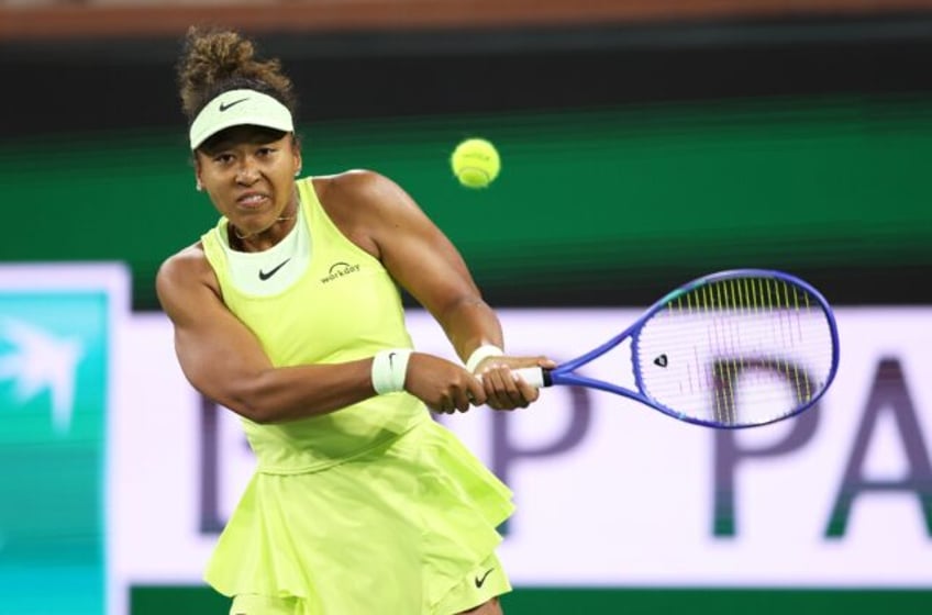 Naomi Osaka of Japan plays a backhand in her first-round loss to Camila Osorio at Indian W