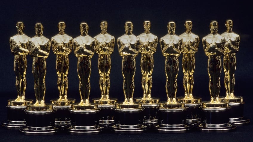 A row of seven Oscar statuettes lined up