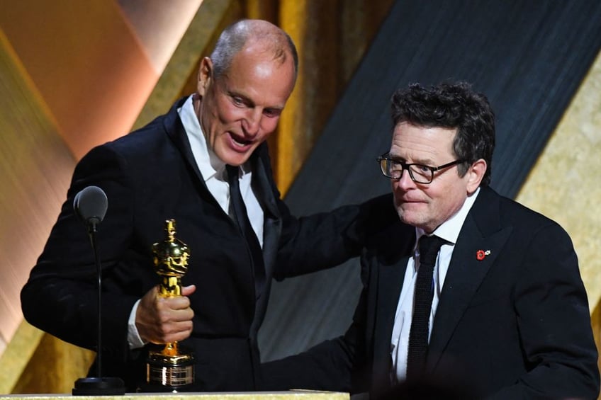 US actor Woody Harrelson presents honoree Canadian-American actor Michael J. Fox with the Jean Hersholt Humanitarian Award during the Academy of Motion Picture Arts and Sciences' 13th Annual Governors Awards at the Fairmont Century Plaza in Los Angeles on November 19, 2022. (Photo by VALERIE MACON / AFP) (Photo by VALERIE MACON/AFP via Getty Images)