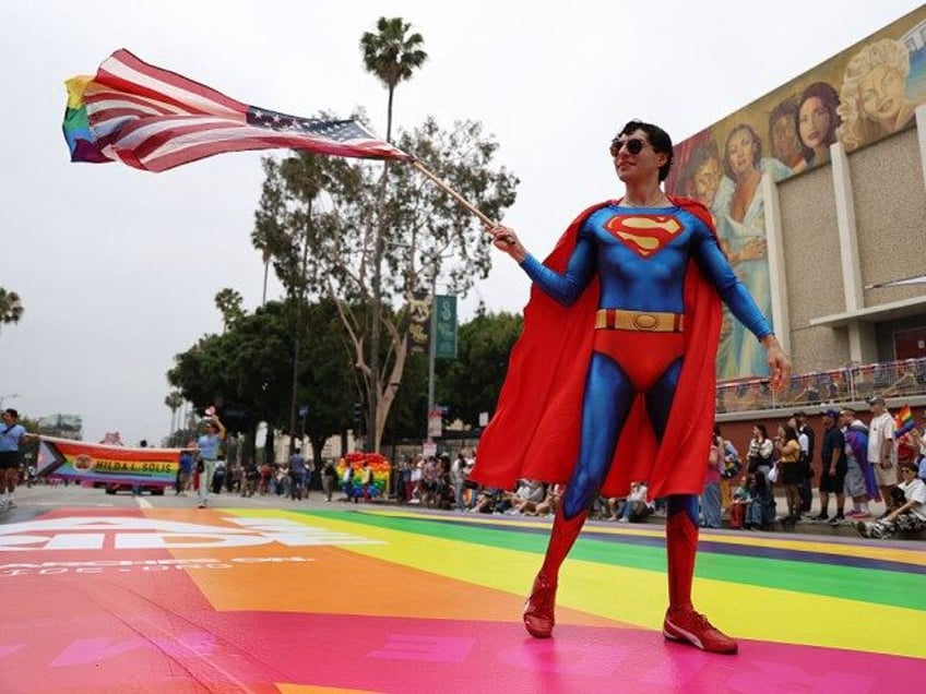 A parade participant dressed as Superman waves a flag during the 55th Annual LA Pride Para