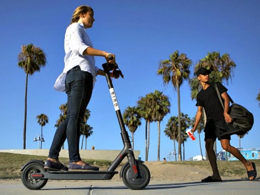 https://media.gettyimages.com/photos/woman-rides-a-bird-shared-dockless-electric-scooter-along-venice-on-picture-