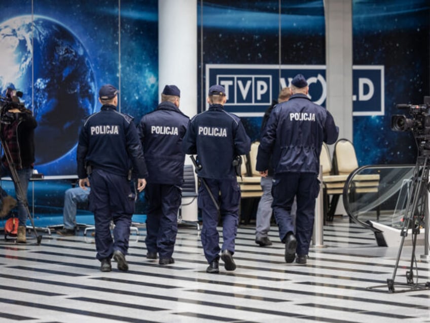 A group of police officers are seen entering the headquarters of Polish Public TV in Warsaw, on December 20, 2023. Polish right-wing populists staged a sit-in in the state television buildings to protest reforms of the national broadcaster, widely seen as a government mouthpiece during their eight years in power. …