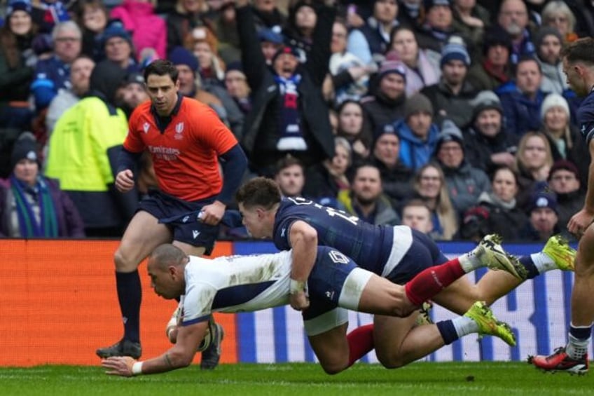 Scotland's Huw Jones (C) tackles France's Gael Fickou (L) in the Six Nations in Edinburgh