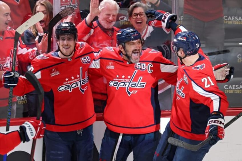 Alex Ovechkin of the Washington Capitals celebrates with teammates after scoring his 888th