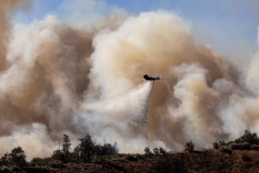 The Mountain Fire grew to burn over 20,000 acres (8,100 hectares) in the first two days, w